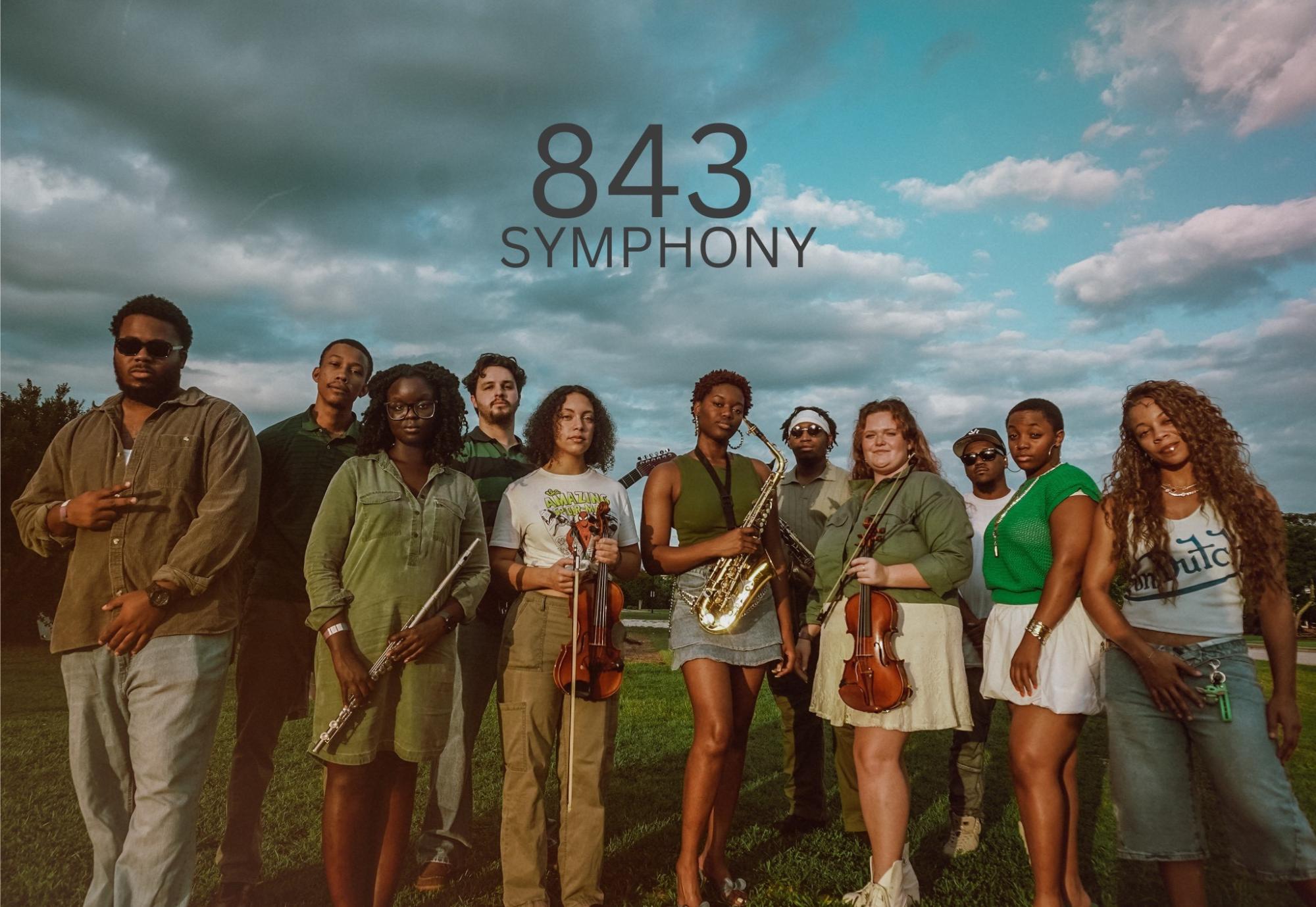 A group of diverse young musicians holding traditional orchestra instruments.