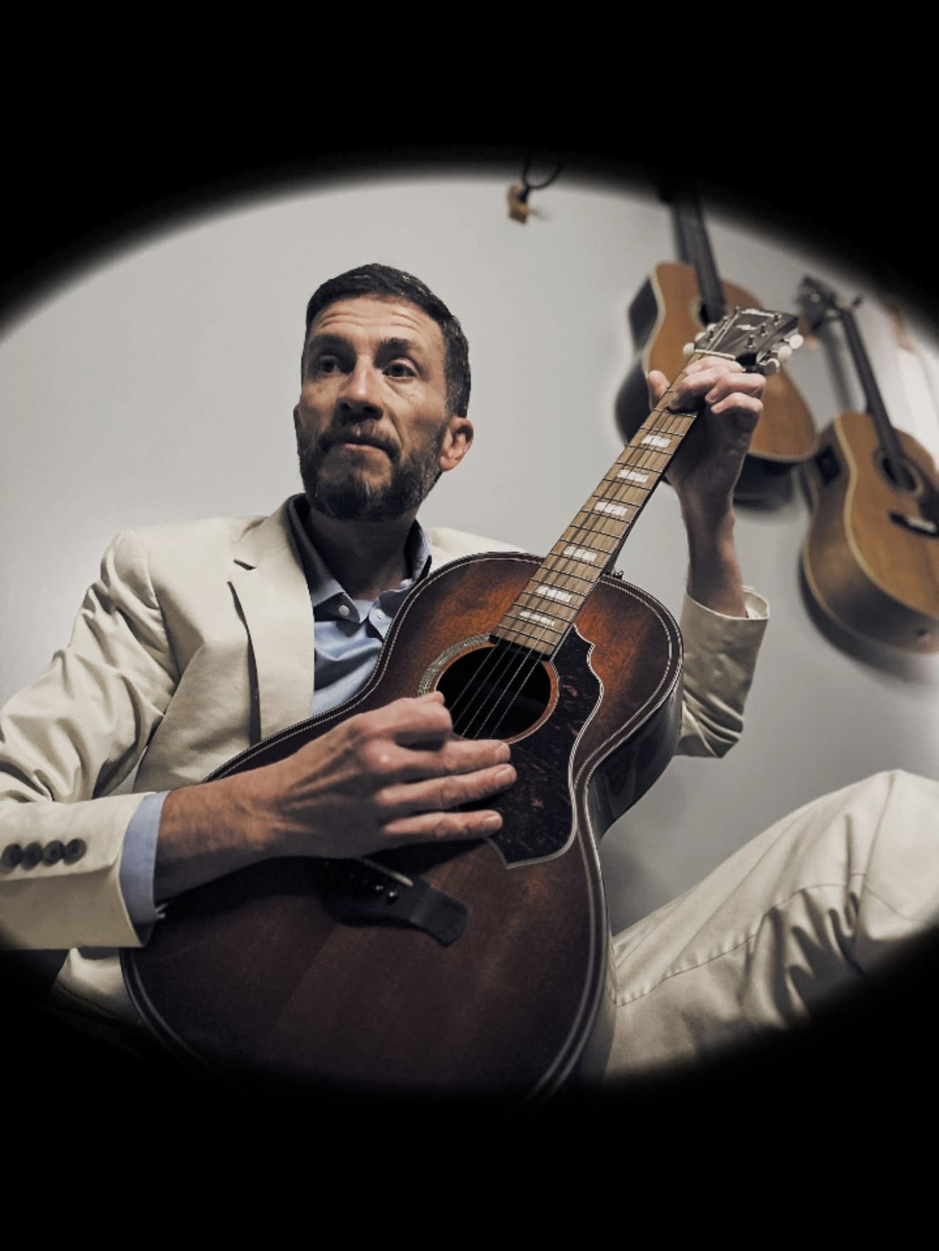 Carolina Slim, Blues Artist, holding a guitar.