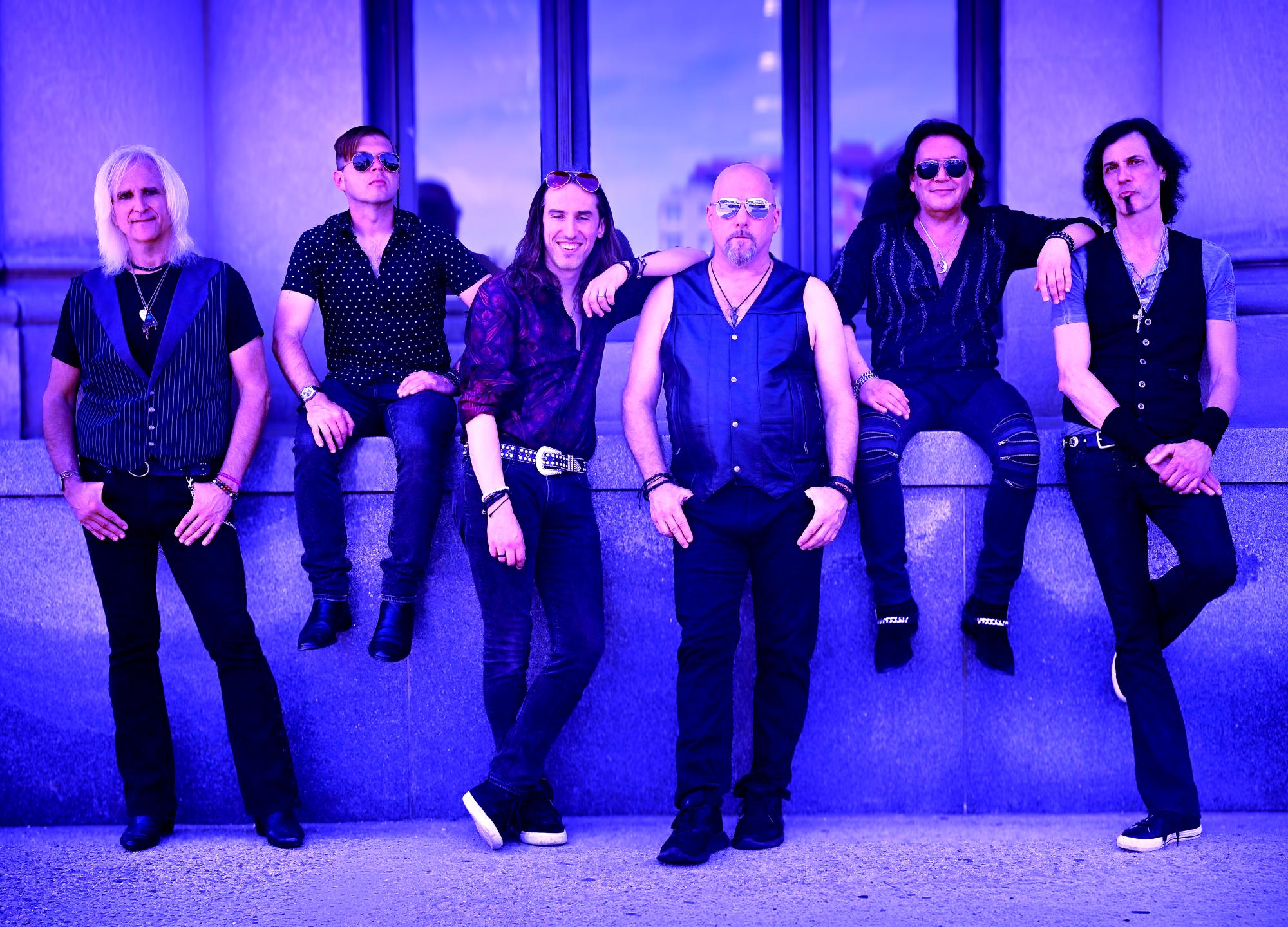 Double Vision: The Foreigner Experience sits on a wall.