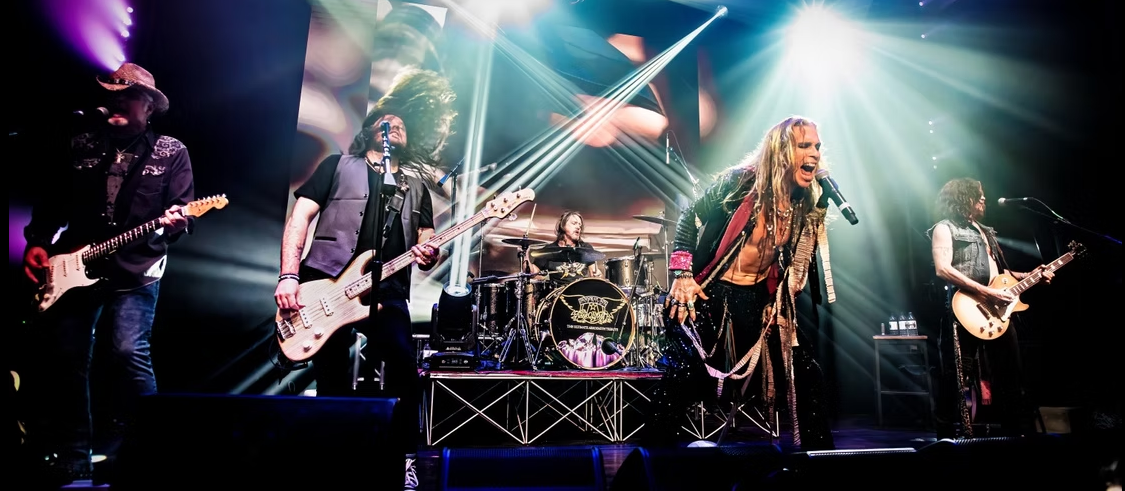 Pandora's Box: a Tribute to Aerosmith plays on a stage. The singer resembles Steve Tyler