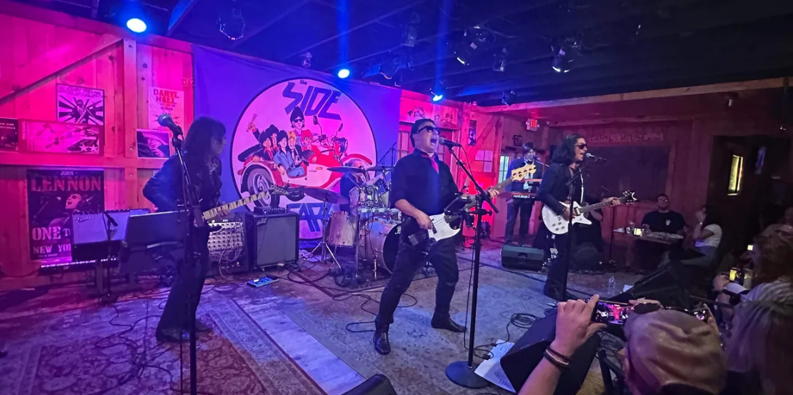 The Side Cars Band performs in a dark room