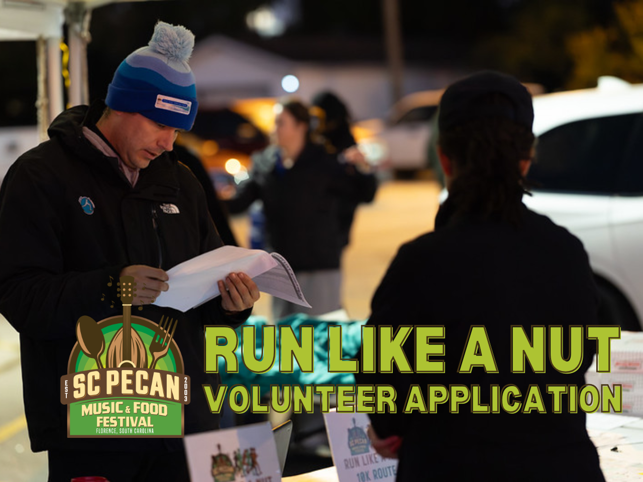volunteer reviews race information for Run Like a Nut